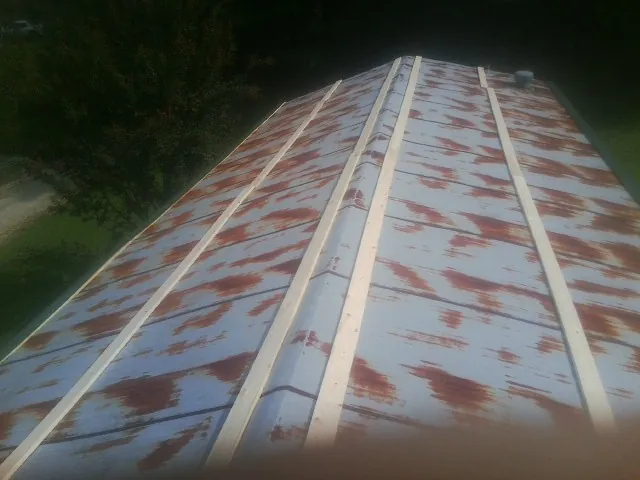 Rusted metal roof panels with new wood purlins before replacement — Storm Damage Roof Repair in Friendship by Roofing Brothers