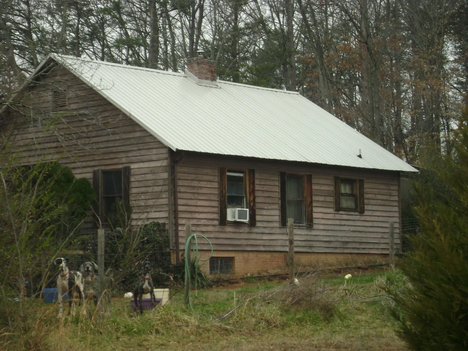 White metal roof on an old wood sided farmhouse, from a Metal Roof Installation job in Friendship